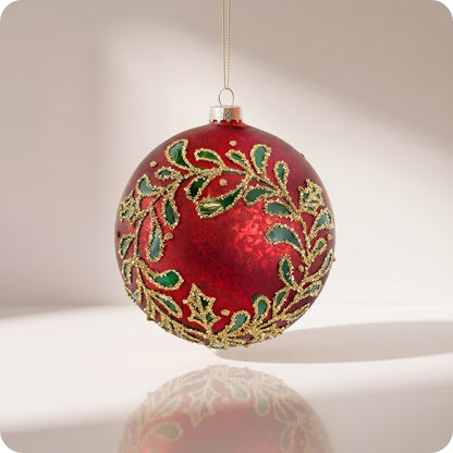 Esfera de cristal rojo con hojas verdes y brillos dorados 12 cm