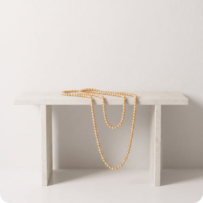 Guirnalda de pearl string doradas